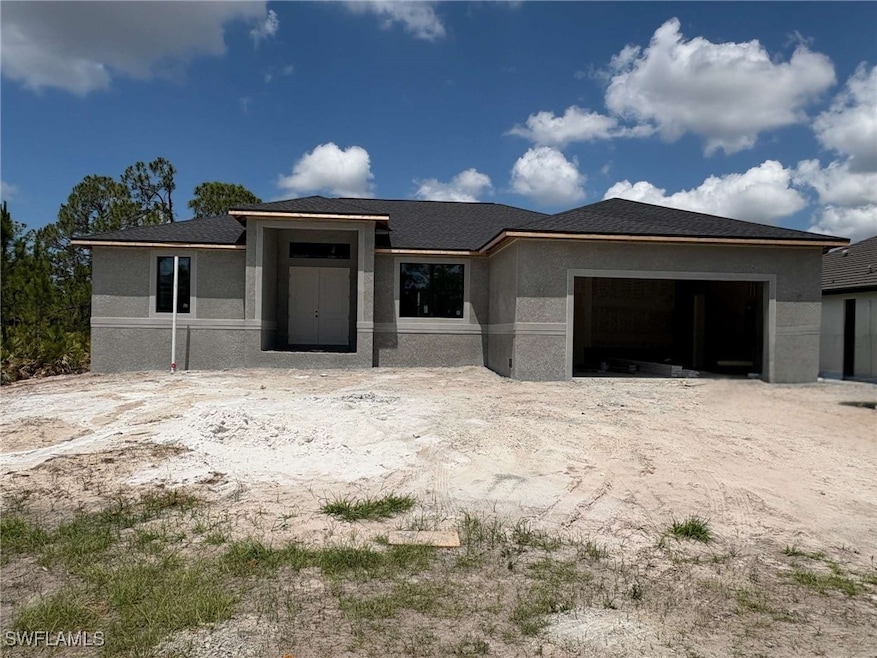 Florida-style home with a garage, stucco siding, a