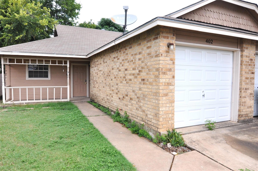 Single story home featuring a garage, brick sidin