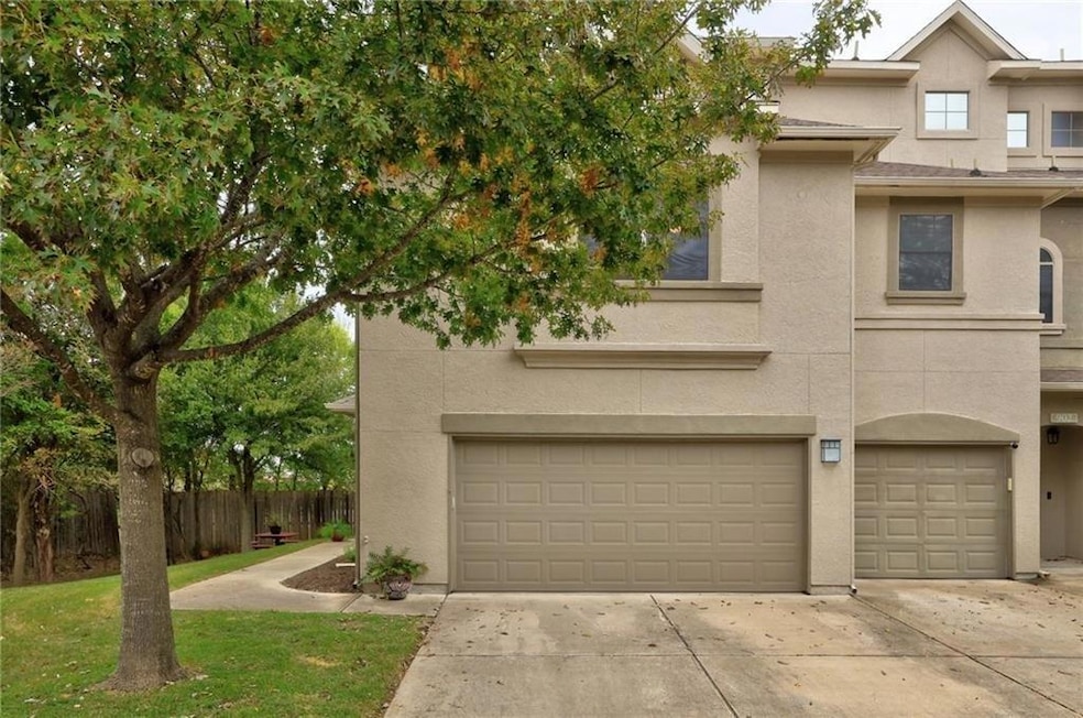 Townhome / multi-family property featuring a gara