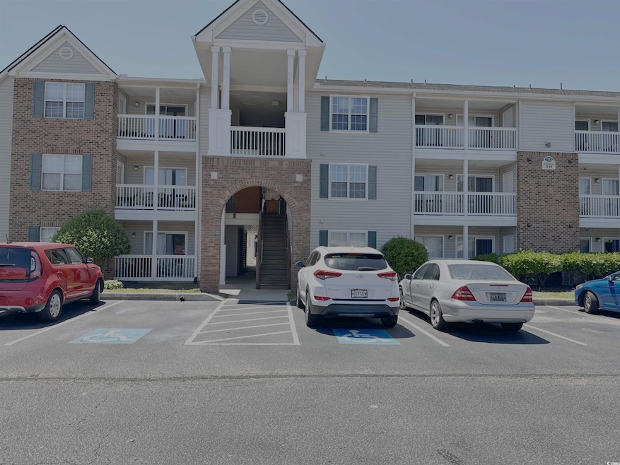 View of building exterior with uncovered parking