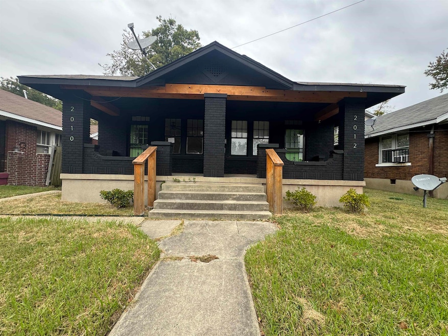 Bungalow-style home featuring a porch, a front lawn, and brick siding