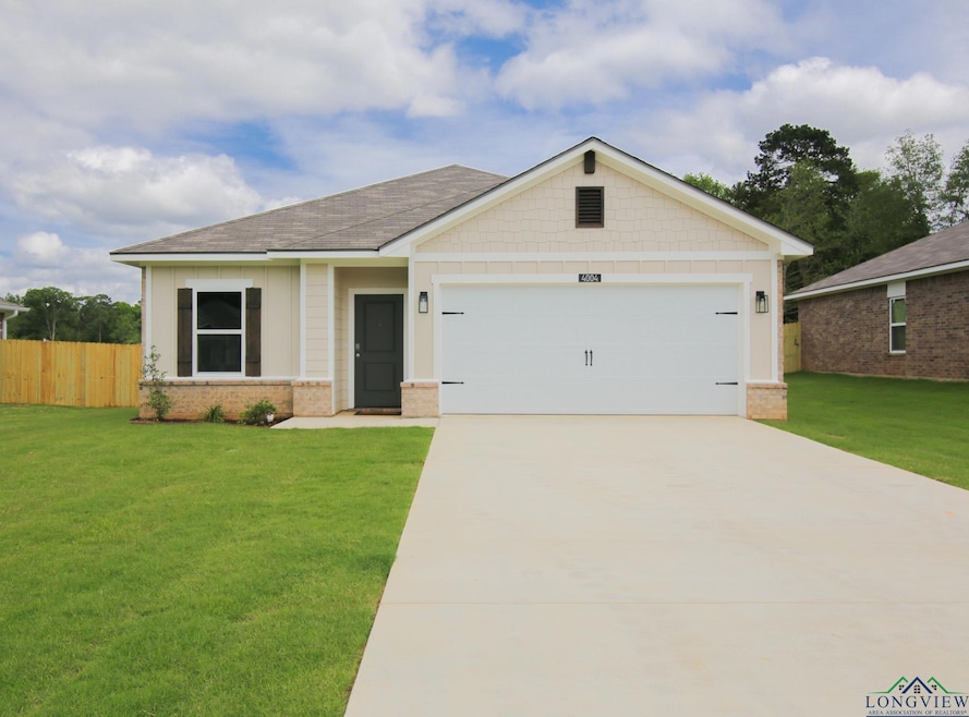 View of front of home featuring concrete driveway, an attached garage, brick siding, and roof with shingles