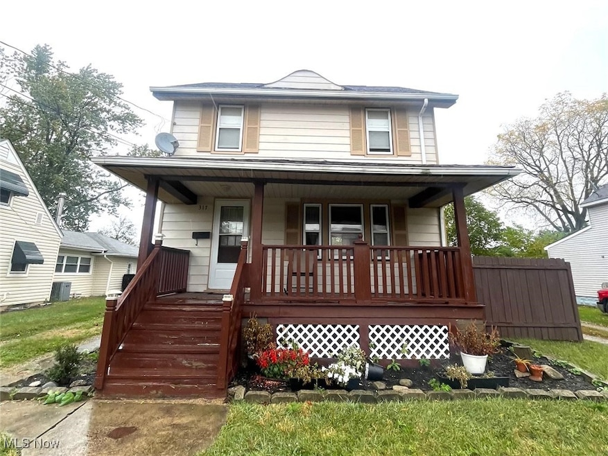 American foursquare style home featuring covered porch