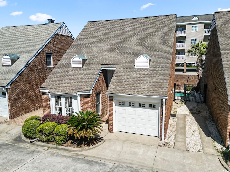 View of front of home with concrete driveway, a sh