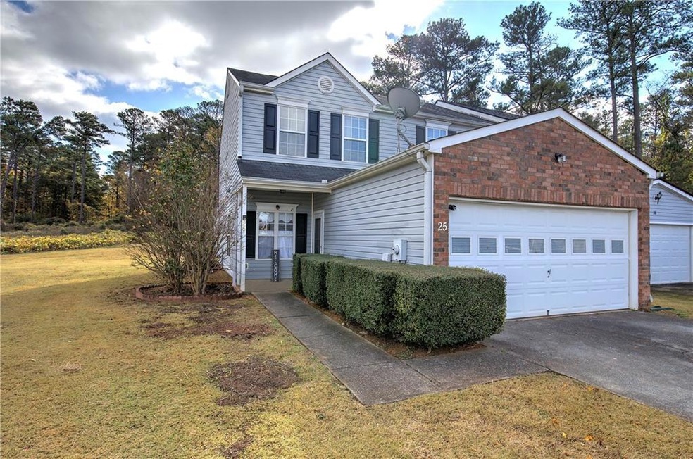 Traditional-style house featuring a front lawn, concrete driveway, a porch, and an attached garage
