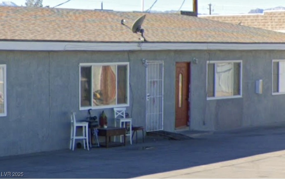 Rear view of house featuring roof with shingles an