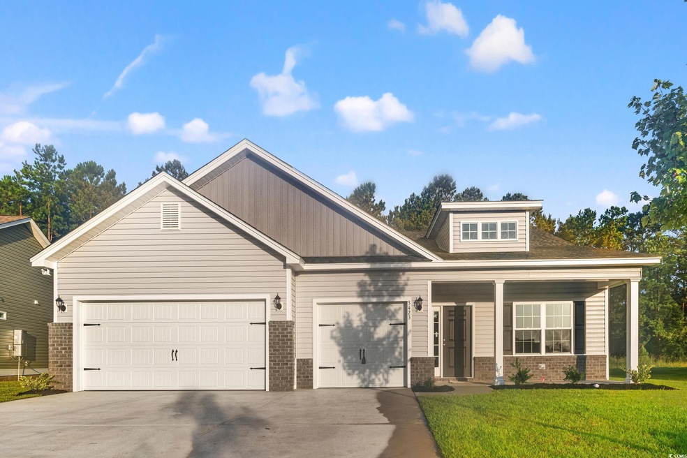 Craftsman inspired home featuring a garage and a f
