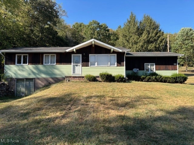 Ranch-style home featuring a front yard
