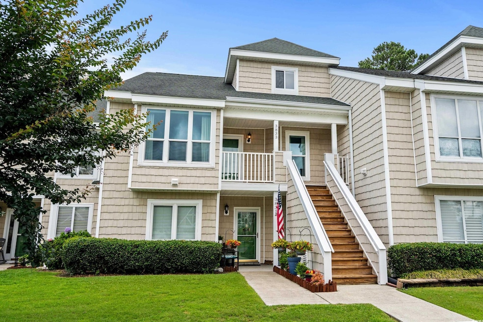 View of property featuring stairs, a front yard, a porch, and roof with shingles