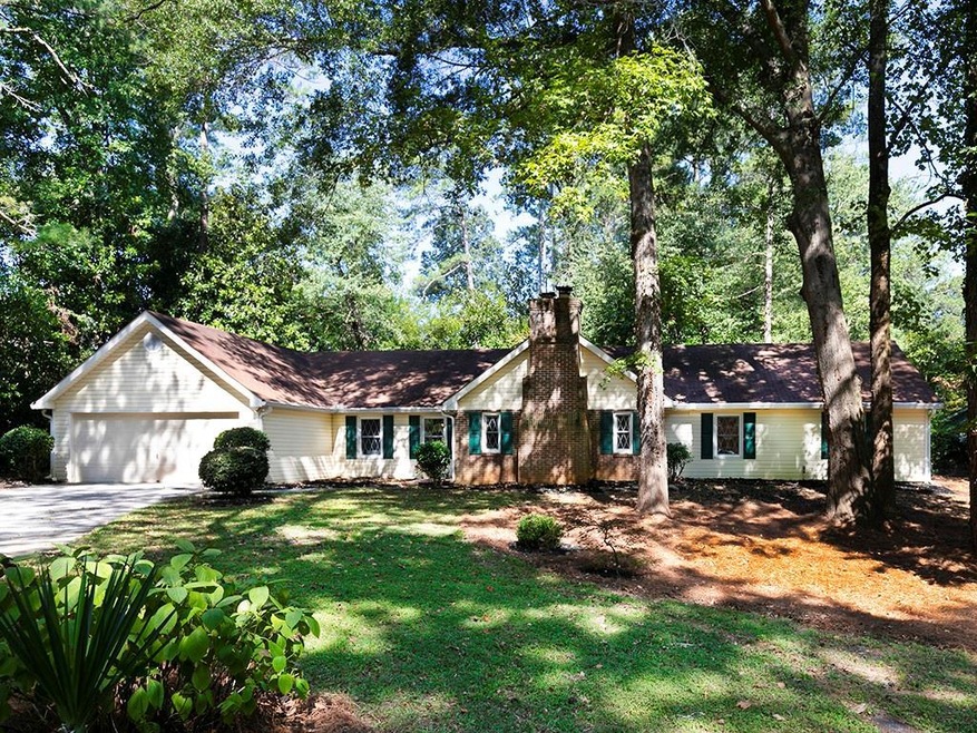 Single story home with a garage and a front yard