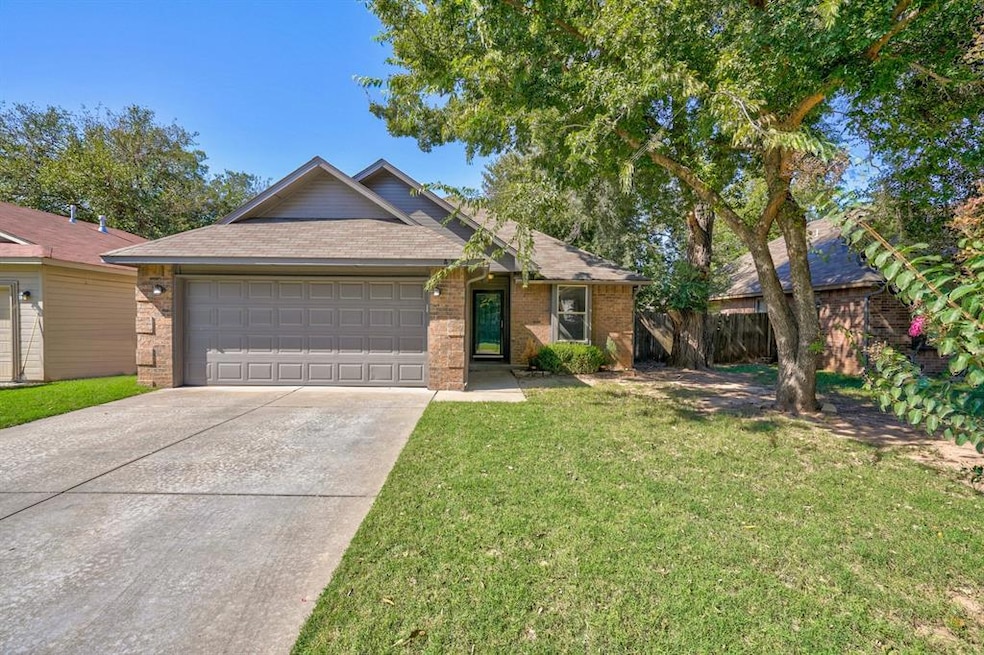Ranch-style house featuring a garage and a front lawn