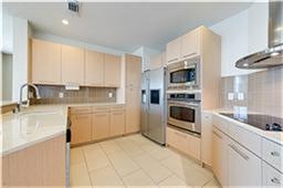 Gourmet kitchen with stainless  appliances opens t