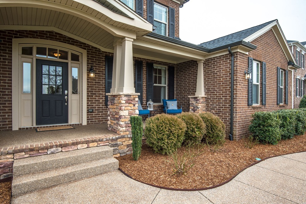 Warm and inviting front porch - with beautiful stone work and an all-brick exterior!