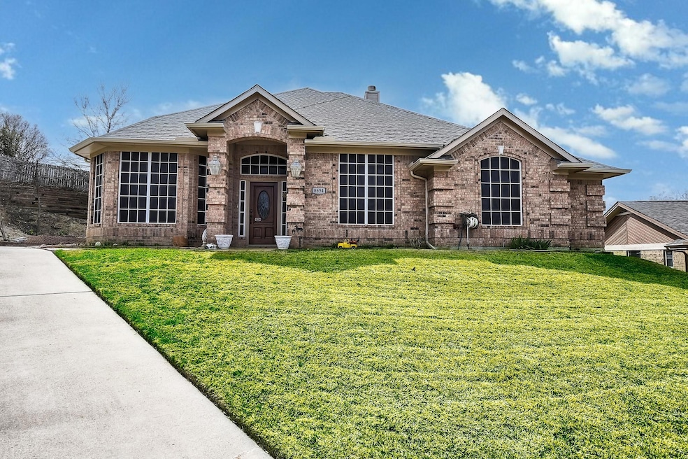 View of front facade with a front yard, a chimney,