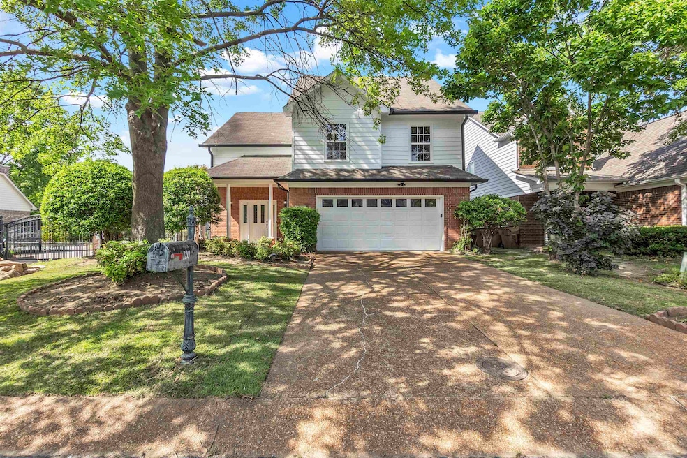 Traditional-style house with brick siding, drivewa