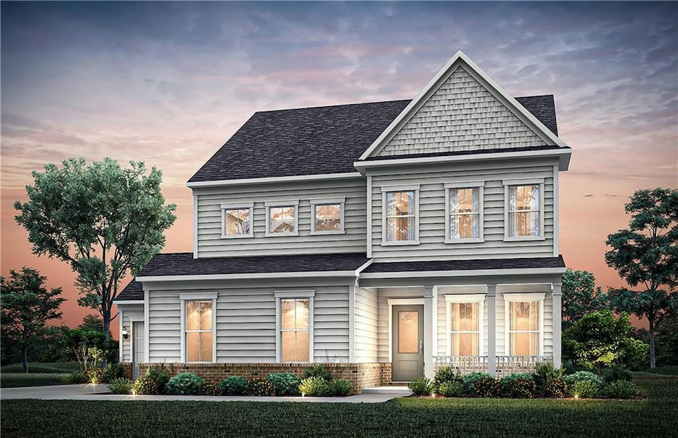View of front facade with brick siding, roof with shingles, and a lawn