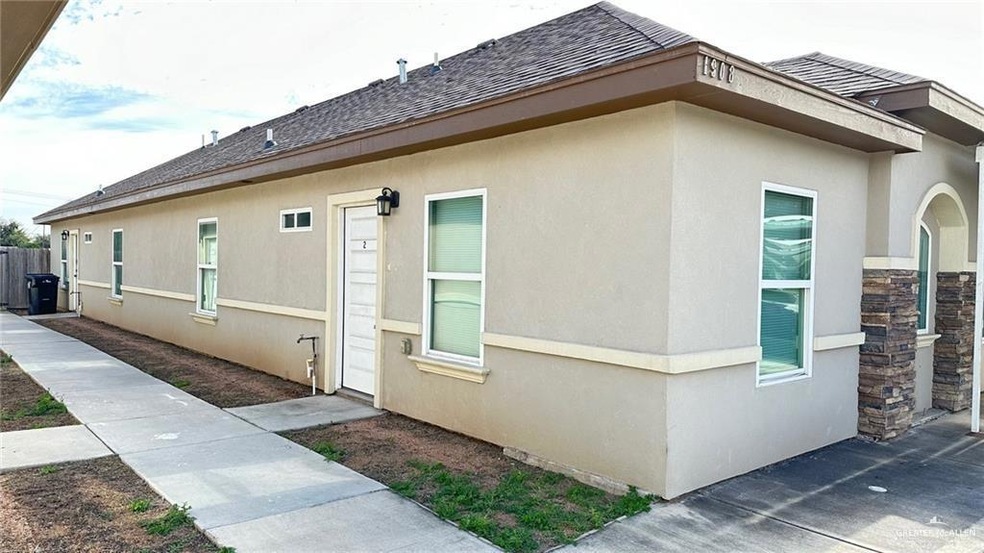 View of side of property featuring stucco siding and roof with shingles