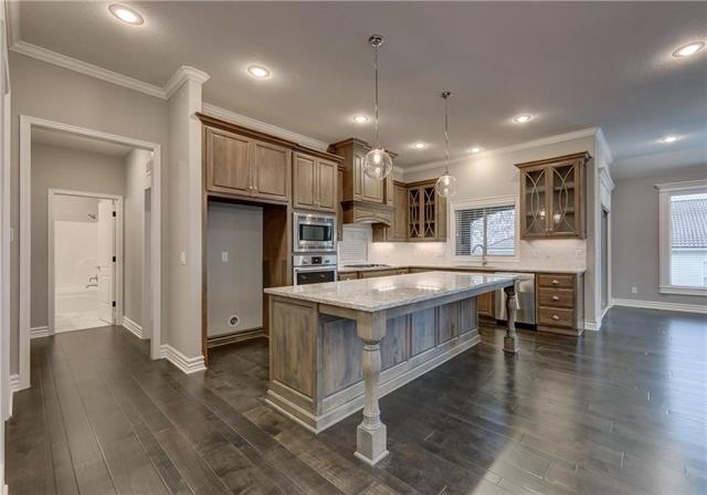 Designer chef’s kitchen includes black silgranite 