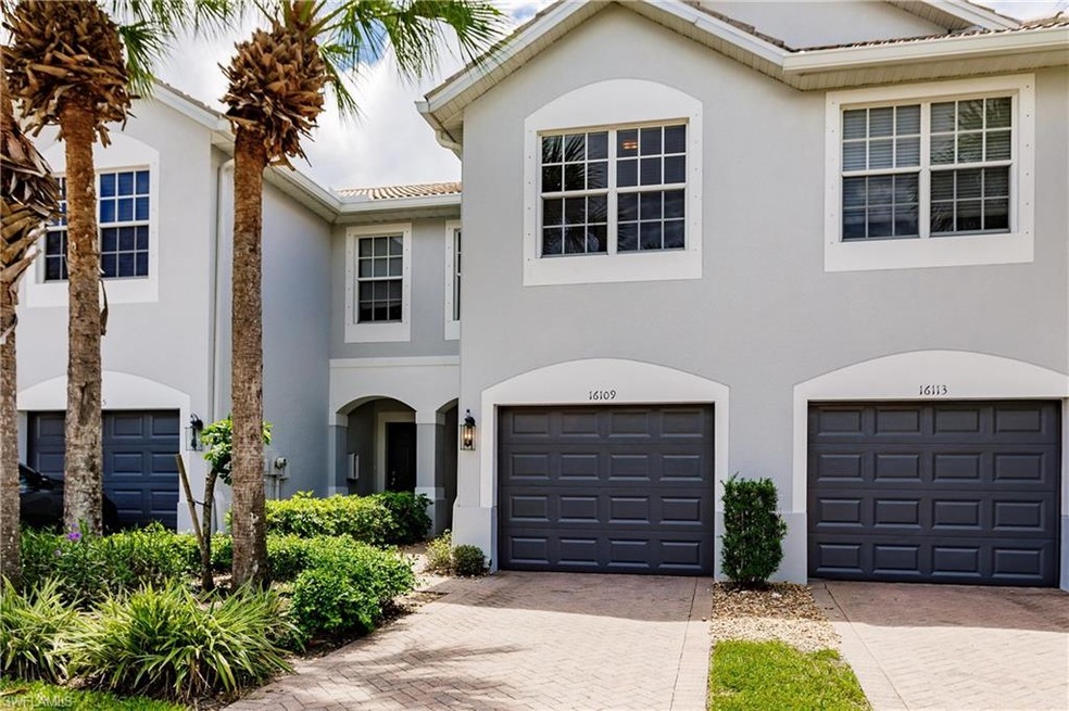 Front of home with paver drive way and single car 