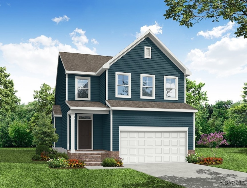 View of front of home with a garage and a front ya