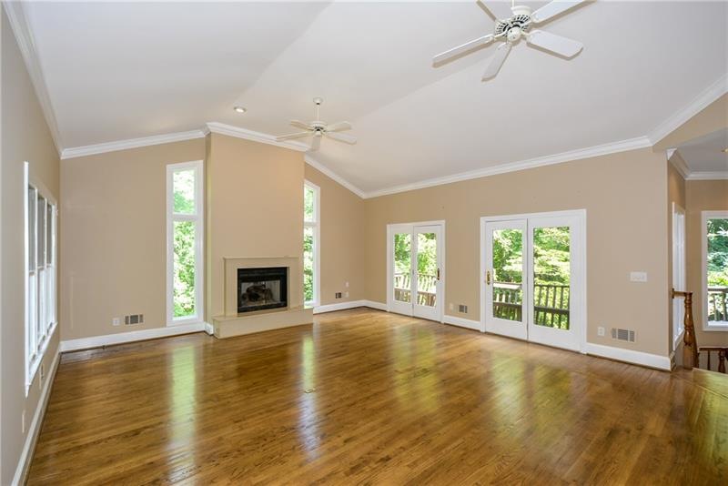 A light filled great room with an exit to the deck