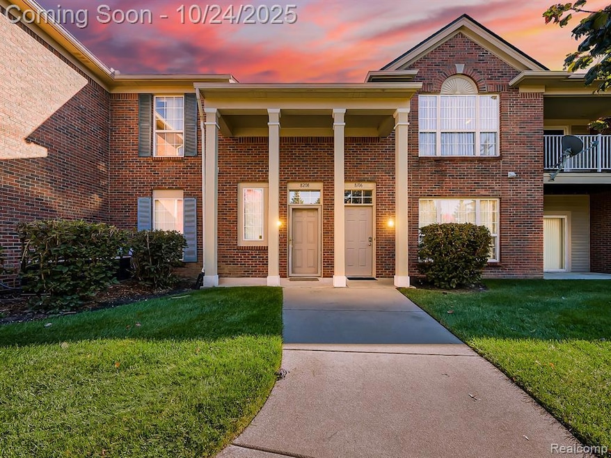 View of front of house with brick siding and a front yard