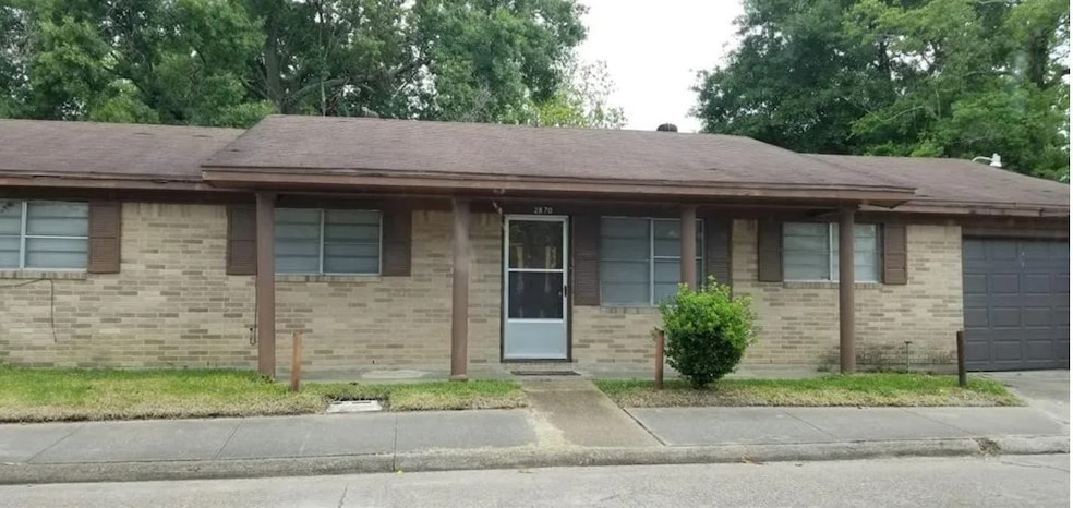 This is a single-story brick home with a simple de