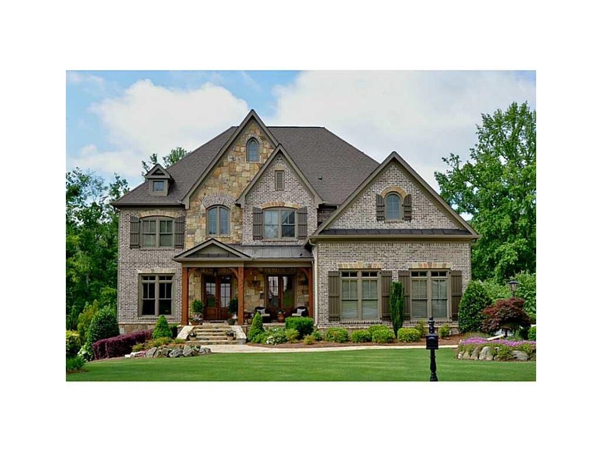 Exterior Front. Custom brick & stone home with stu
