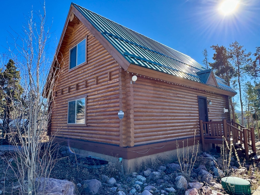 View of side of property with log exterior and a metal roof