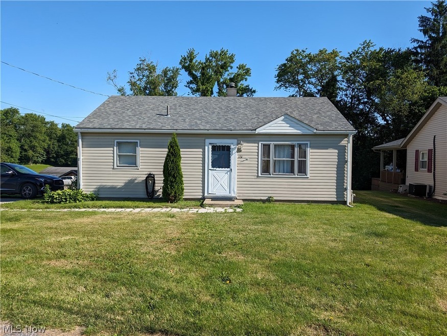 View of front of house featuring a front lawn and central AC unit