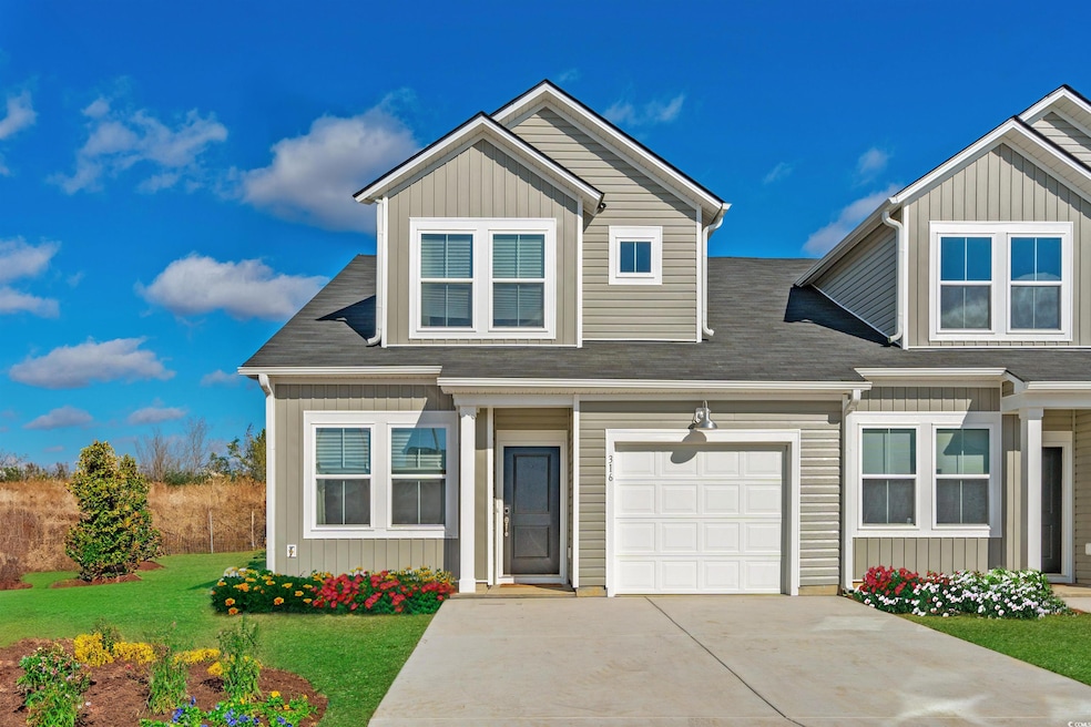 View of front of property featuring driveway, an a