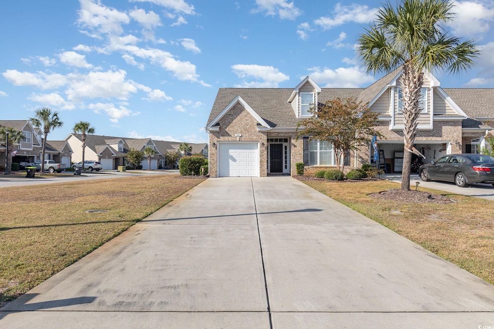 View of front of house with a front lawn and a gar