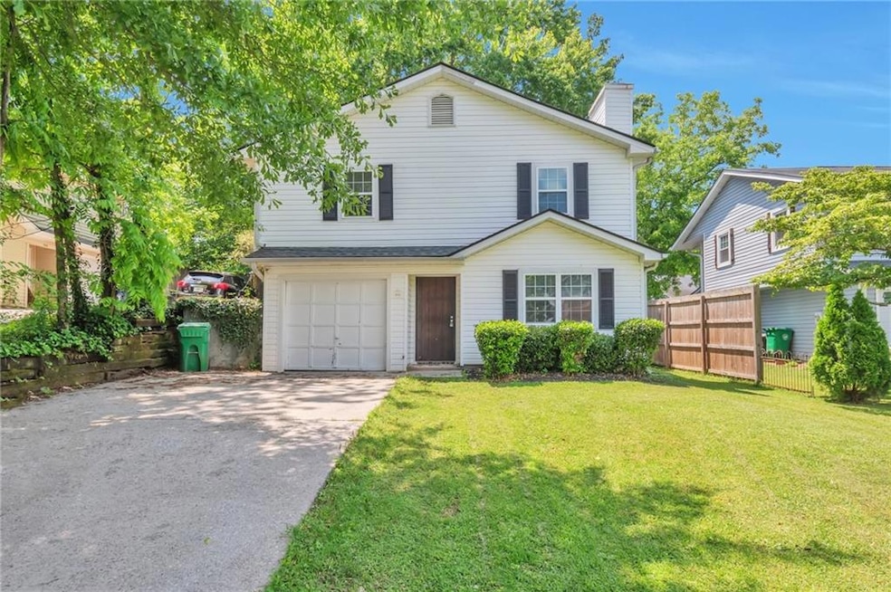 Traditional home with a garage, a chimney, and driveway