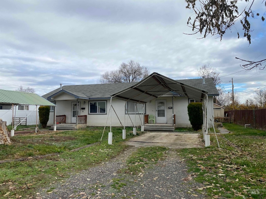 View of front of property featuring covered porch and a shingled roof