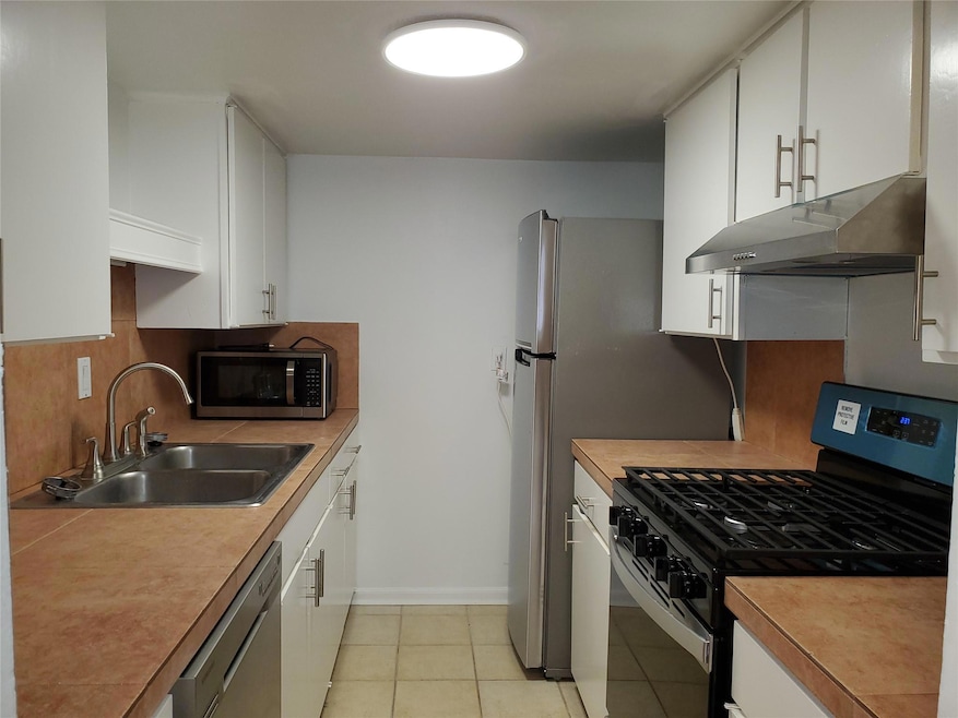 Kitchen featuring stainless steel appliances, a s