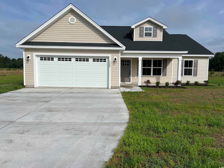 View of front of property with an attached garage and concrete driveway