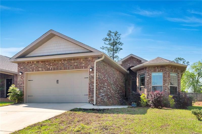 Two car garage with concrete driveway and walkway.