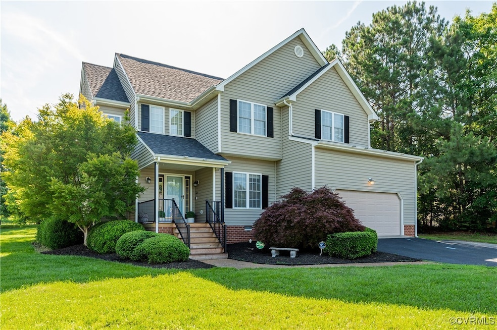 View of front of home with a garage, asphalt drive