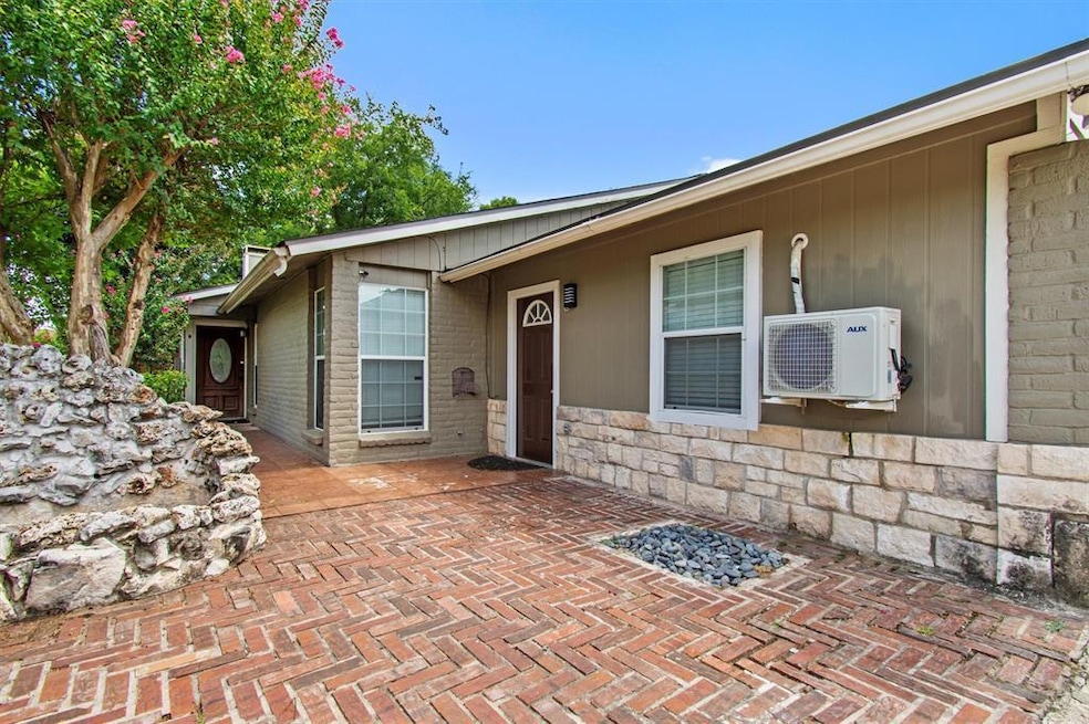 Entrance to property featuring stone siding and a