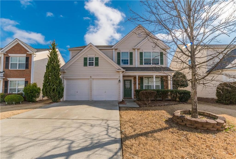 View of front of property with covered porch and a garage