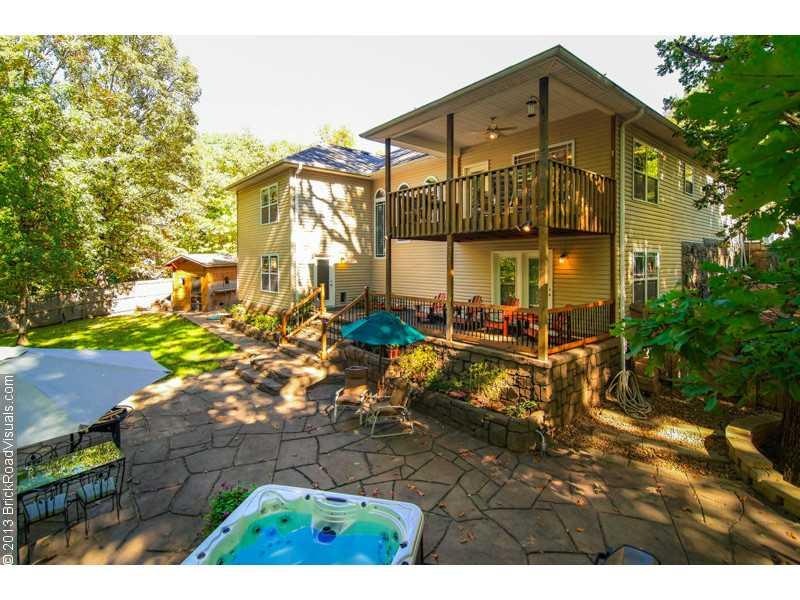 Exterior Back. Double the entertaining options with a lower and upper patio AND a hot tub!