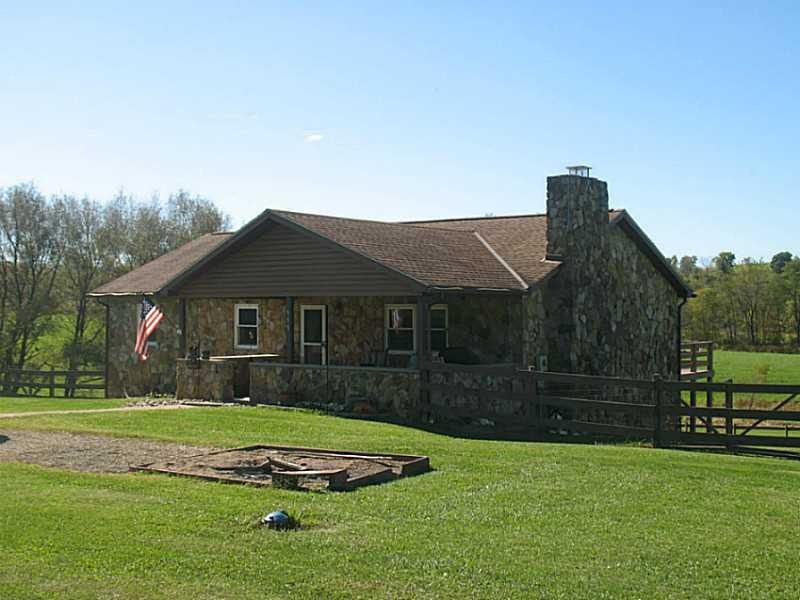 Exterior Front. Unique stone constructed home situ