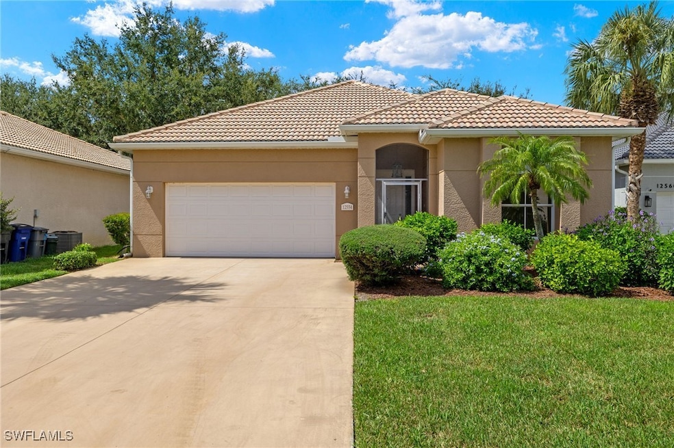 Mediterranean / spanish-style home featuring a gar