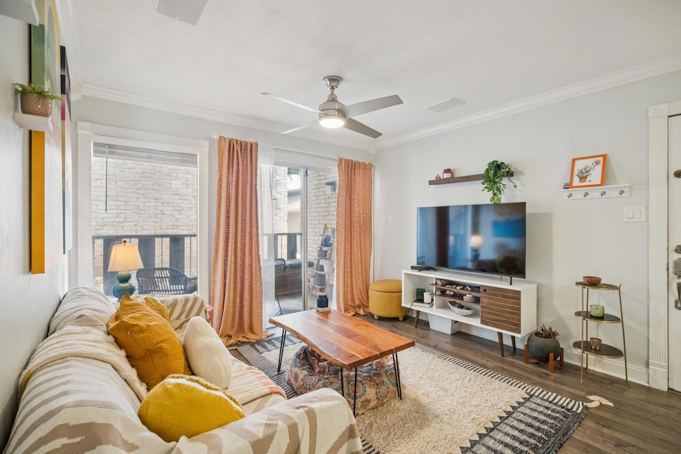 Living area with crown molding, wood finished flo