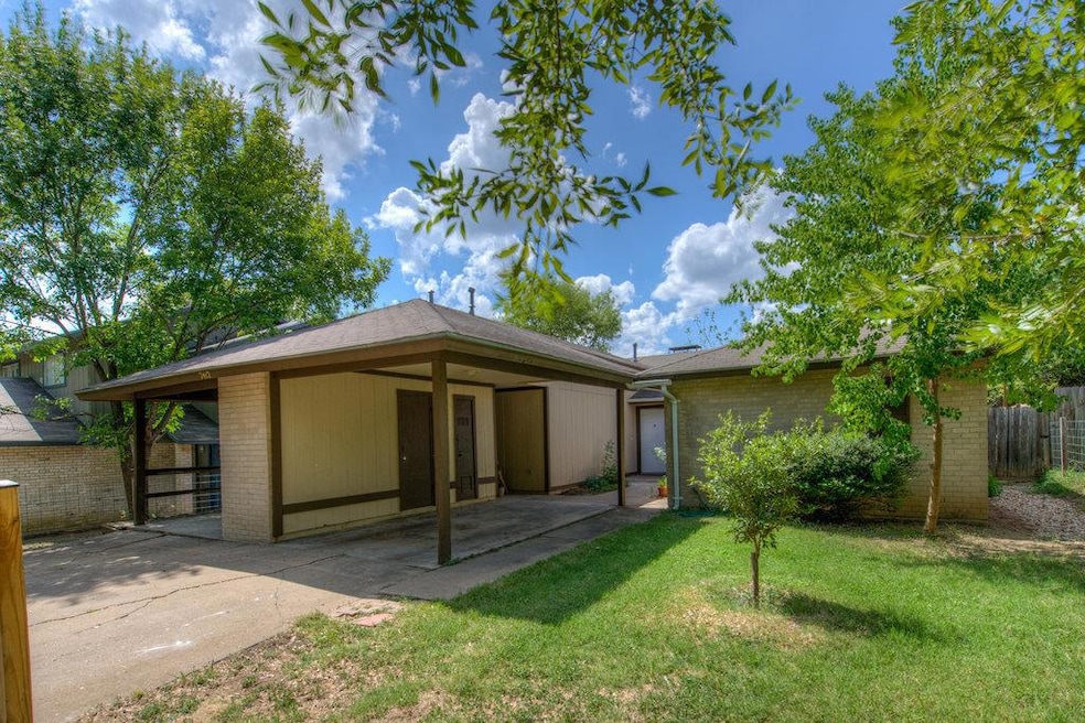View of front of house with brick siding and a pa