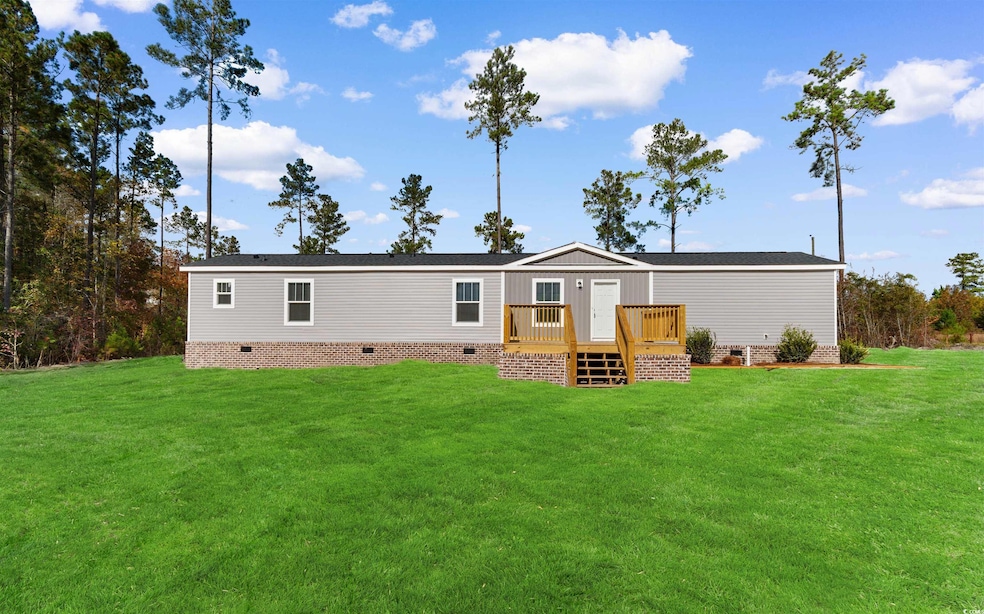 Rear view of property with a lawn