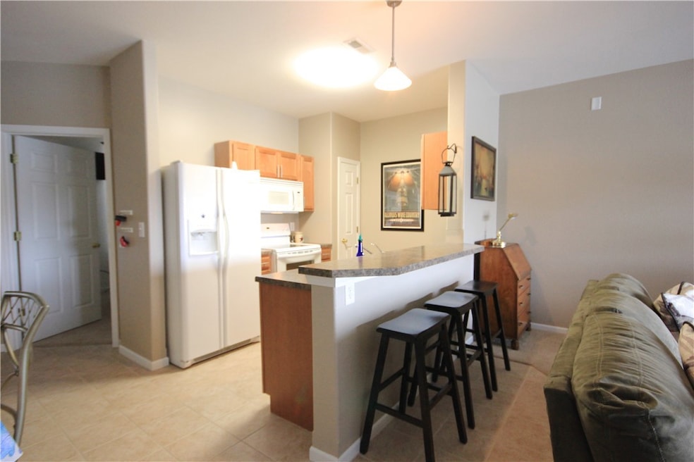 Kitchen features breakfast bar and pantry.
