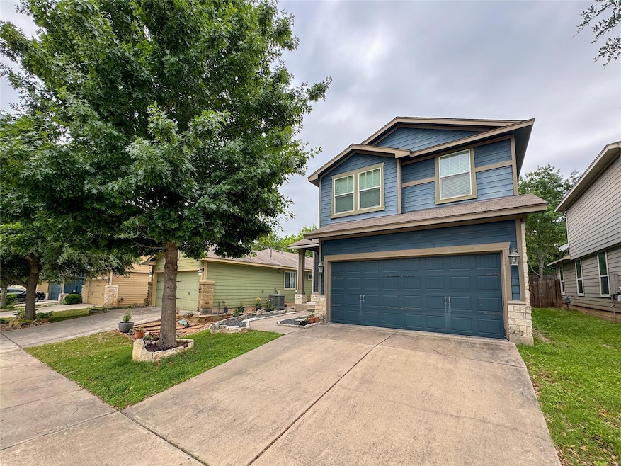 View of front of property featuring a garage, a f
