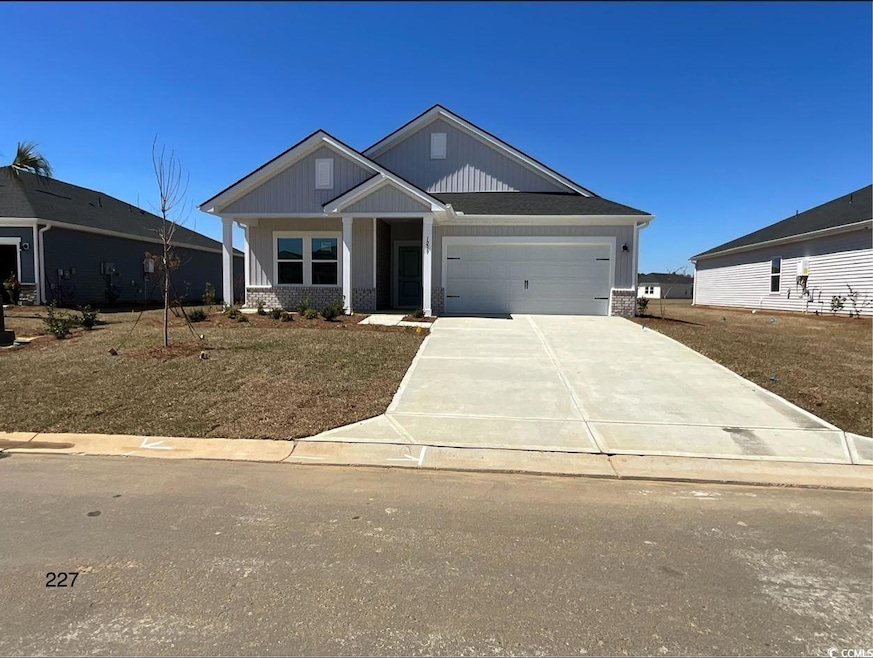 Craftsman-style house featuring a garage, driveway
