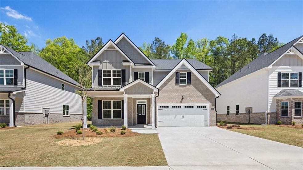 Craftsman inspired home featuring a garage and a f
